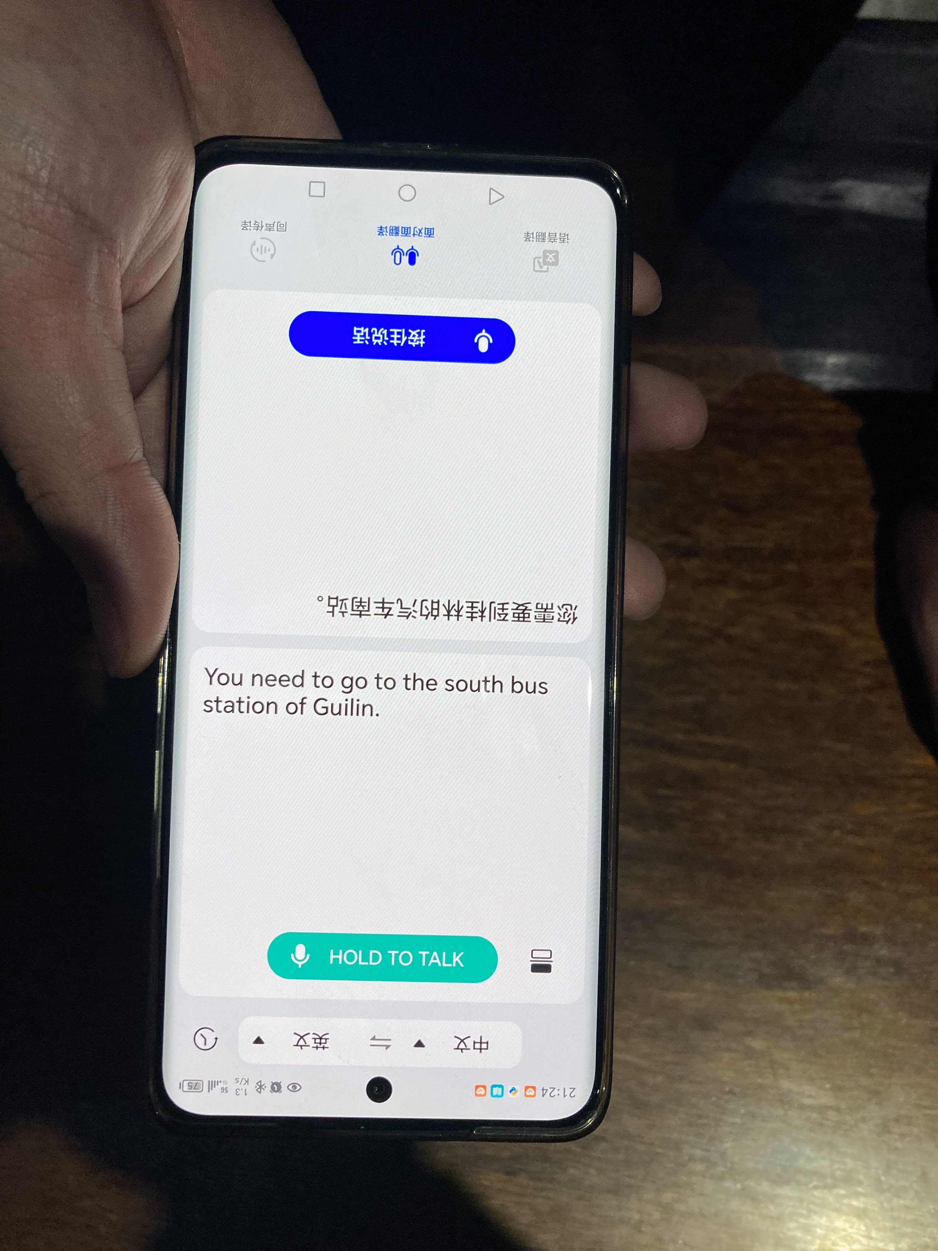 Hotel owner explaining with a translator app where to catch the train