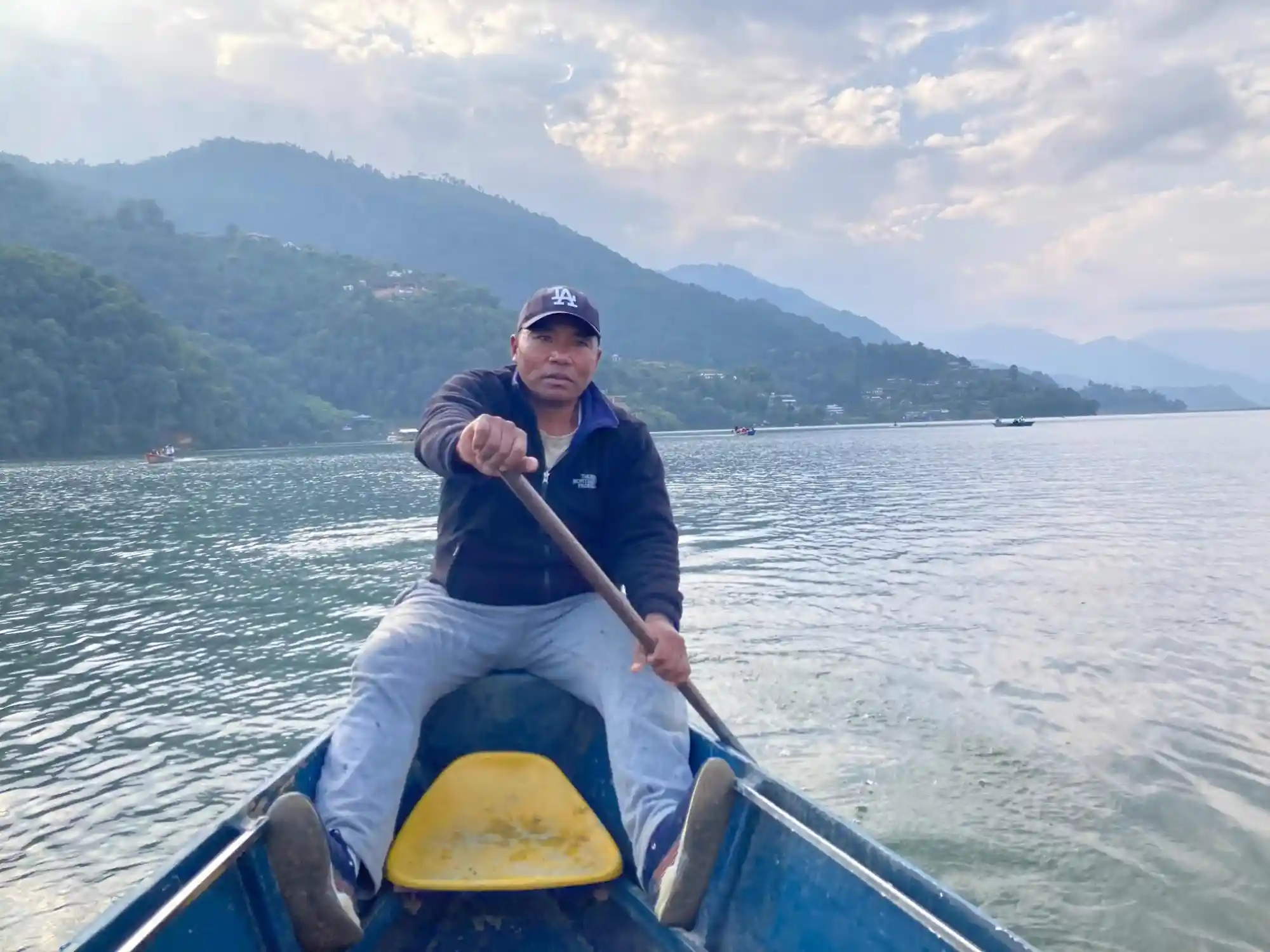 Man driving a boat on Pokhara's lake