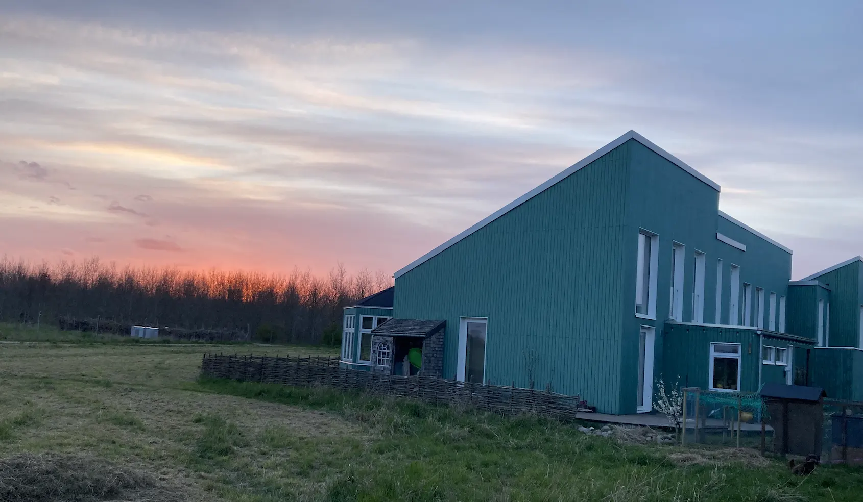 View of a house from the outside at sunset