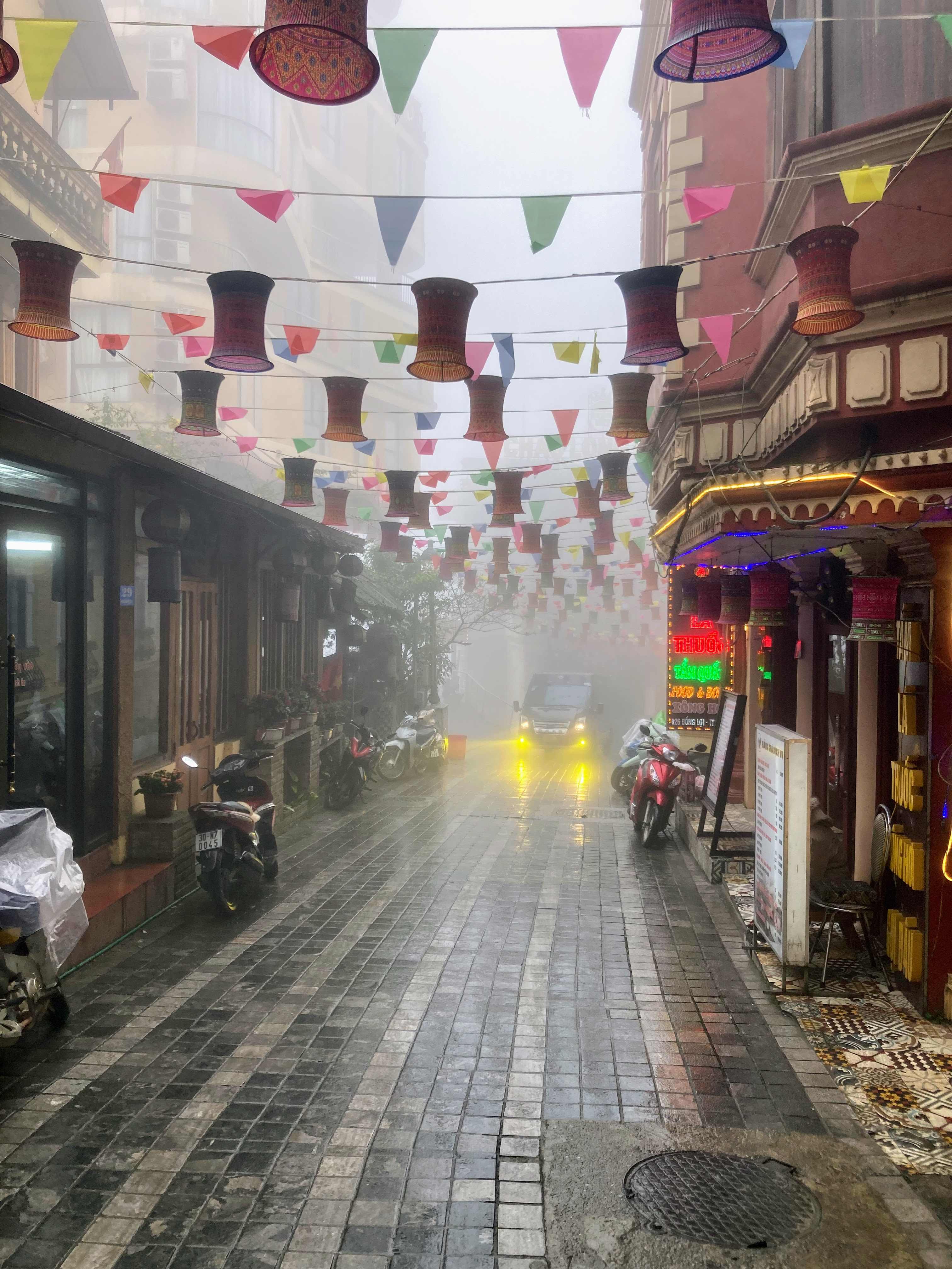 Street of Sa Pa with colorful flags in a rainy afternoon